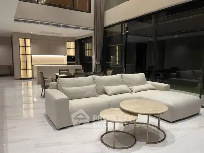 Luxurious modern living room with elegant furniture and open kitchen layout