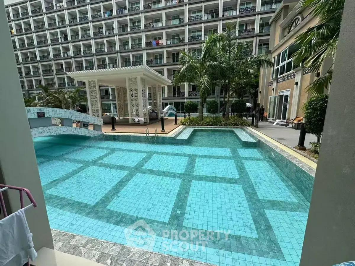 Luxurious apartment complex with a stunning outdoor pool and modern architecture.