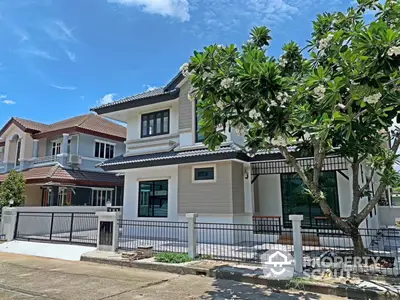 Charming two-story house with lush garden and modern design in a serene neighborhood.