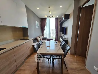 Modern open-plan kitchen and living room with stylish decor and natural light.