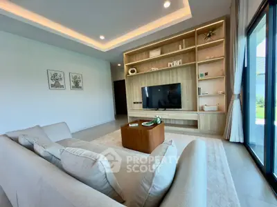 Spacious modern living room with elegant built-in shelving and large windows for natural light.