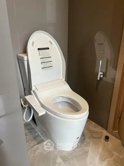 Modern bathroom with sleek toilet and gray tiles