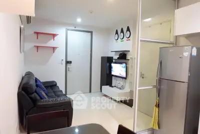 Modern living room with sleek furniture and stainless steel fridge