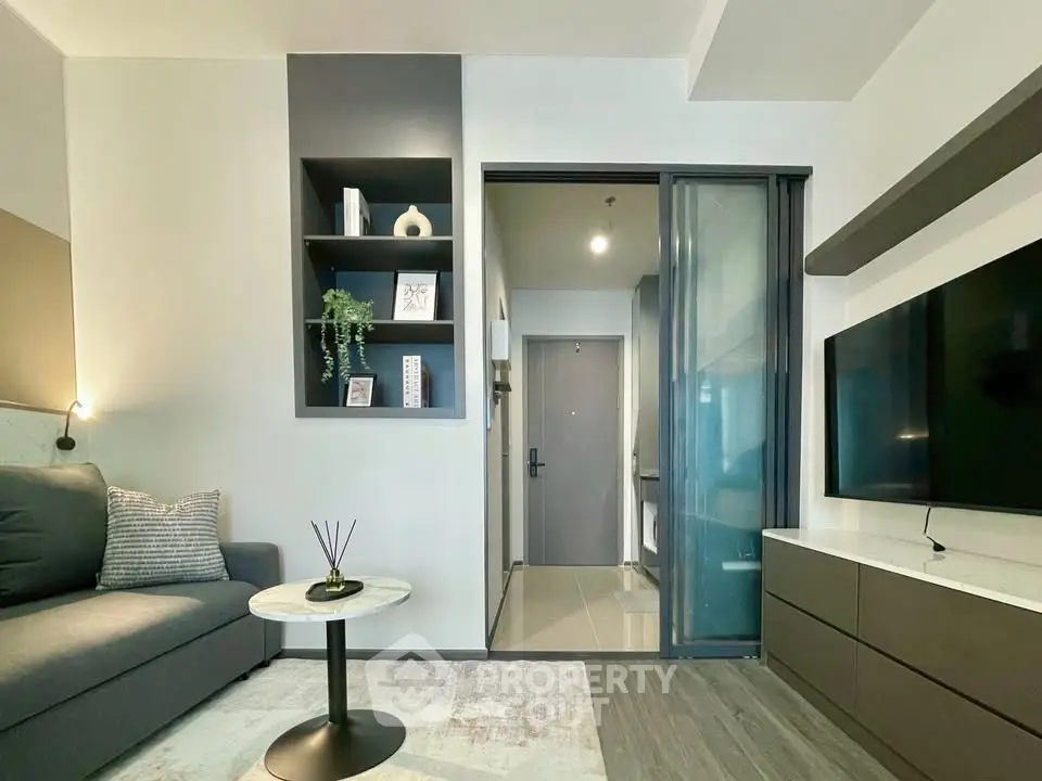 Modern living room with sleek design, featuring a cozy sofa, wall-mounted TV, and stylish shelving.