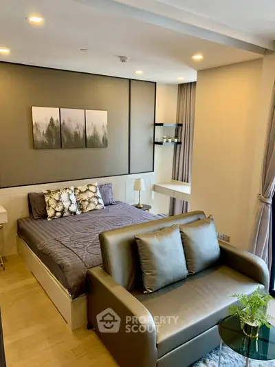 Modern bedroom with stylish decor and cozy seating area in a luxurious apartment.
