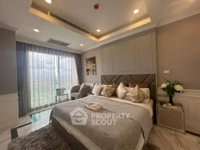 Luxurious bedroom with elegant decor and large window offering stunning views.