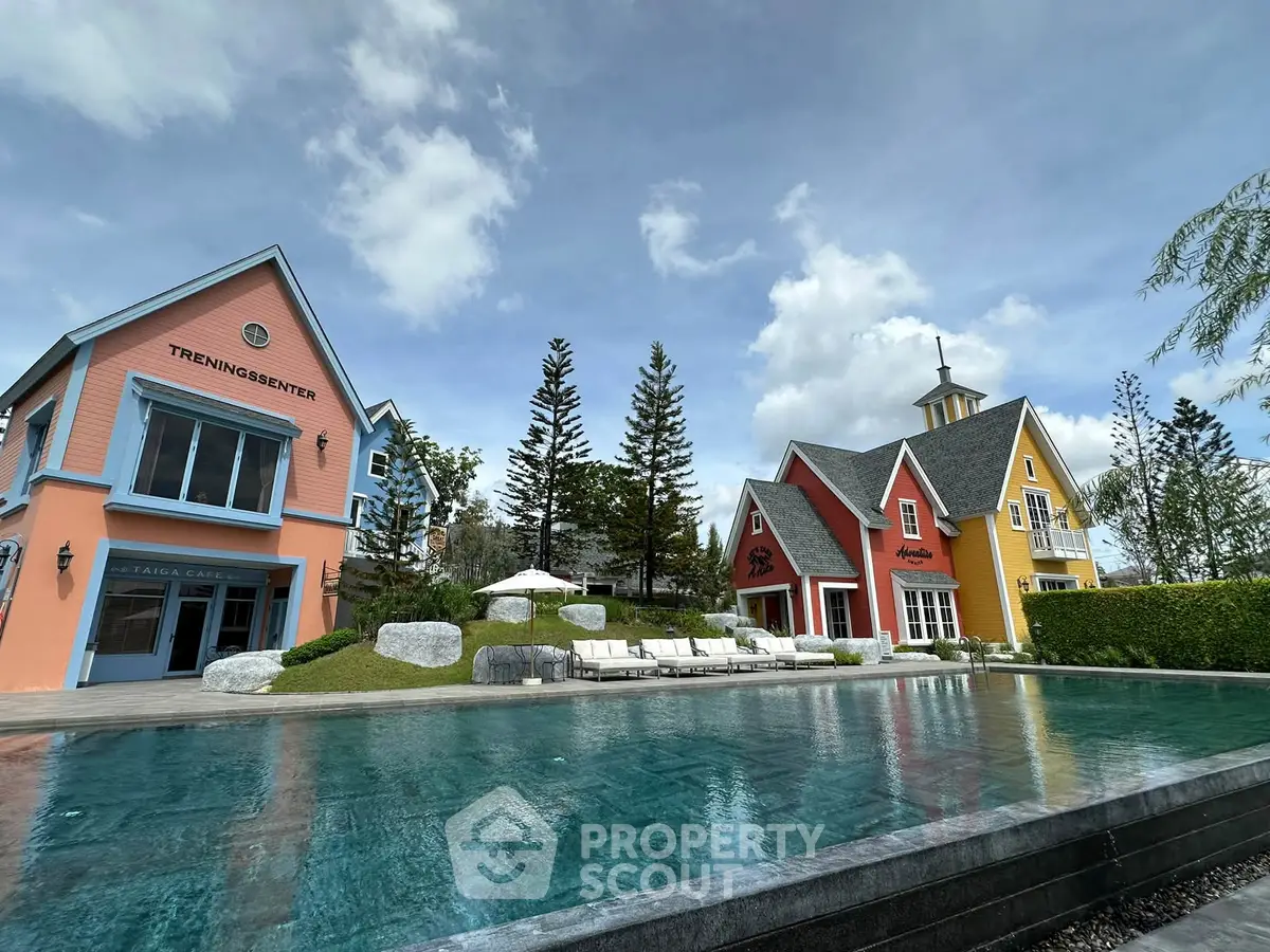 Charming colorful houses with a serene pool and lush greenery, perfect for a tranquil lifestyle.