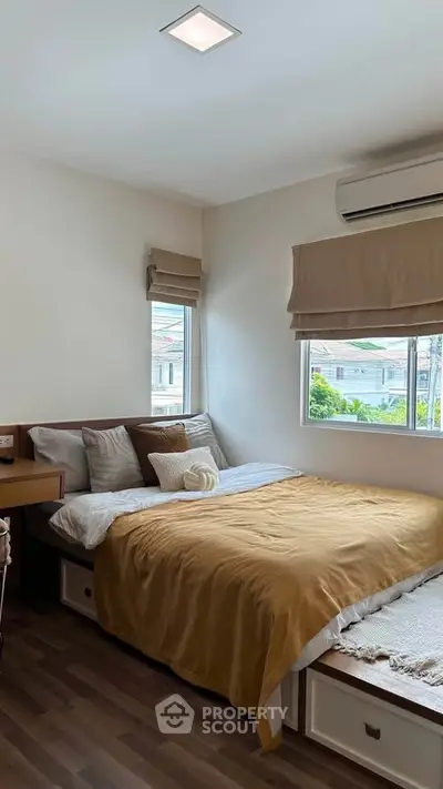 Cozy bedroom with natural light, featuring a comfortable bed and modern decor, perfect for relaxation.