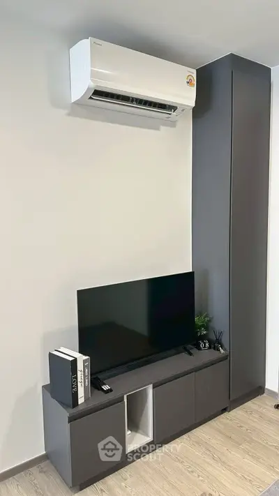 Modern living room with sleek TV unit and air conditioning