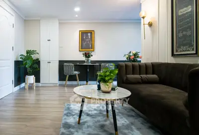 Elegant living room with plush sofa, stylish decor, and cozy ambiance, perfect for modern living.
