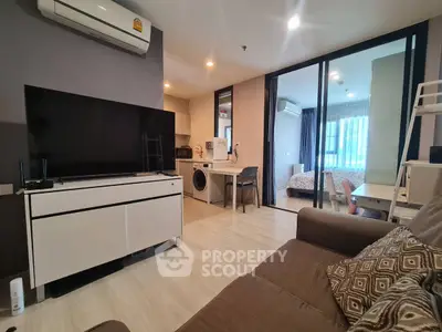 Modern apartment interior with open living room and kitchen, featuring a cozy bedroom view.