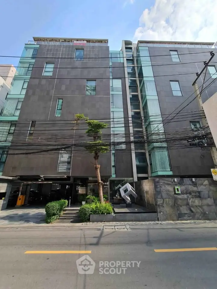 Modern urban apartment building with sleek facade and large windows, ideal for city living.