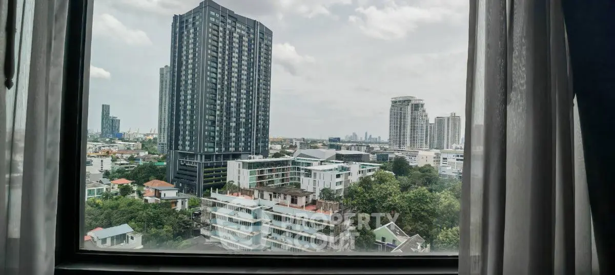 Stunning cityscape view from a high-rise window showcasing modern urban living.
