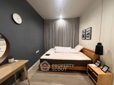 Modern bedroom with stylish decor and cozy ambiance, featuring a comfortable bed and elegant furnishings.