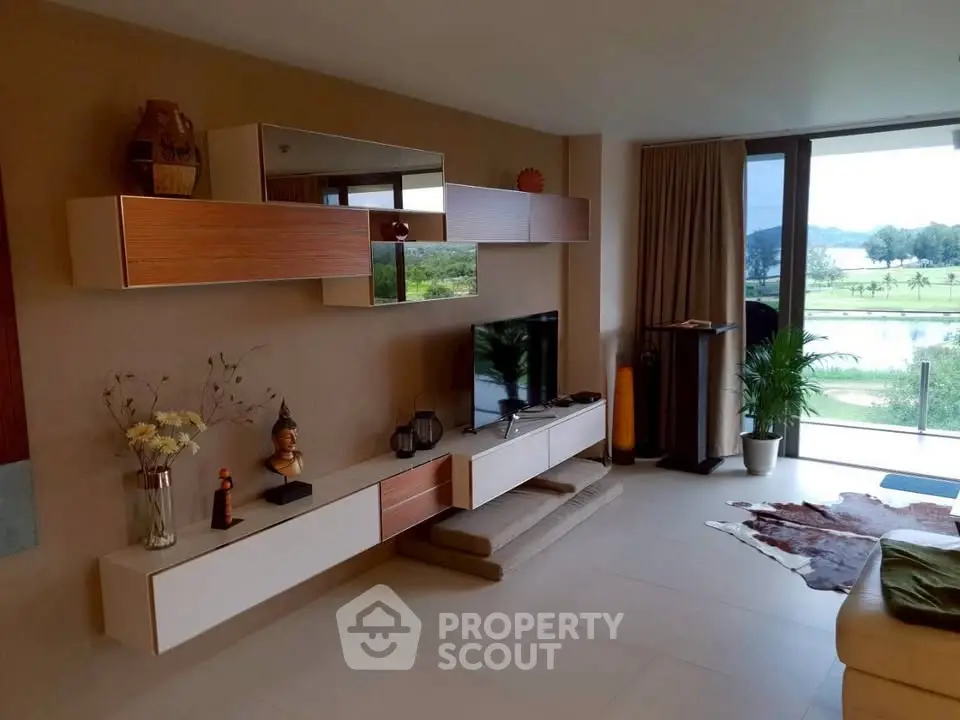 Modern living room with stylish decor and scenic balcony view