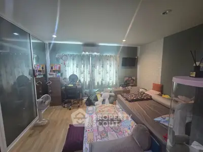 Cozy bedroom with modern decor and ample natural light