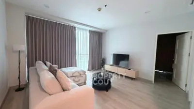 Spacious modern living room with large windows and elegant decor