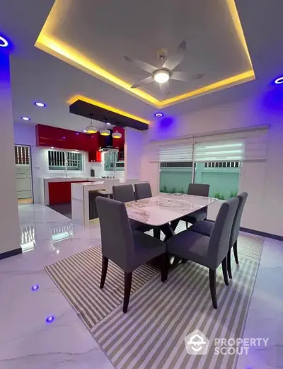 Modern dining area with stylish ceiling lights and open kitchen layout