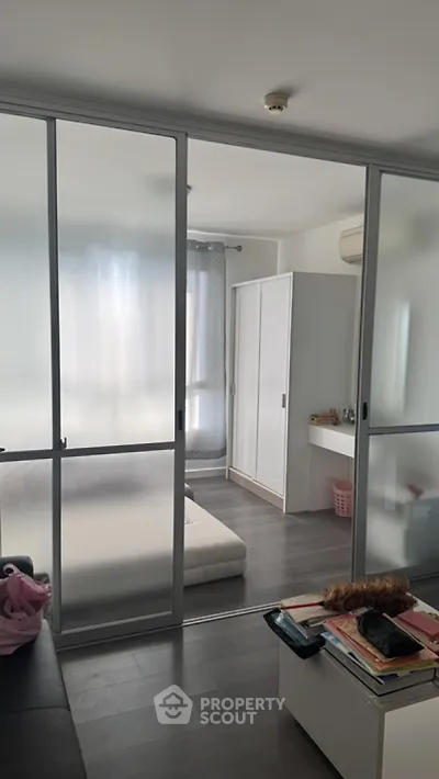 Modern bedroom with sliding glass doors and minimalist decor