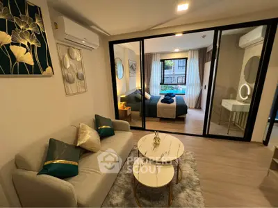 Modern living room with elegant decor and view into stylish bedroom