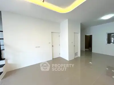 Spacious modern interior with sleek tile flooring and minimalist design, perfect for contemporary living.