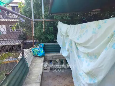 Charming outdoor balcony with privacy screen and tiled flooring, perfect for relaxation.