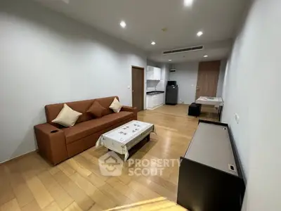 Spacious living room with modern furniture and wooden flooring in a contemporary apartment.