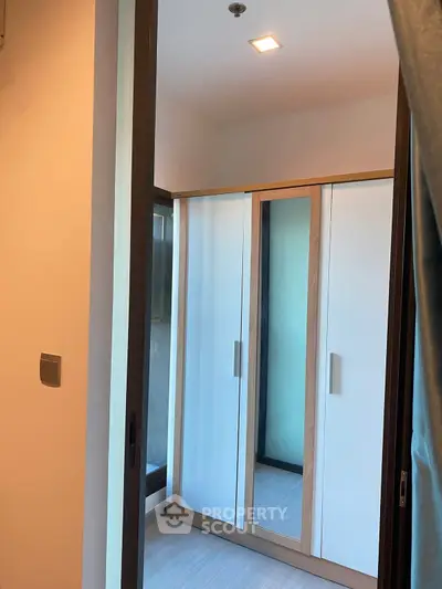 Modern apartment with sleek wardrobe and ample natural light