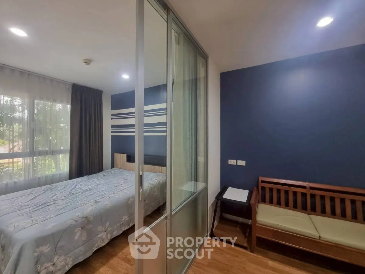 Modern bedroom with sliding glass doors and cozy seating area