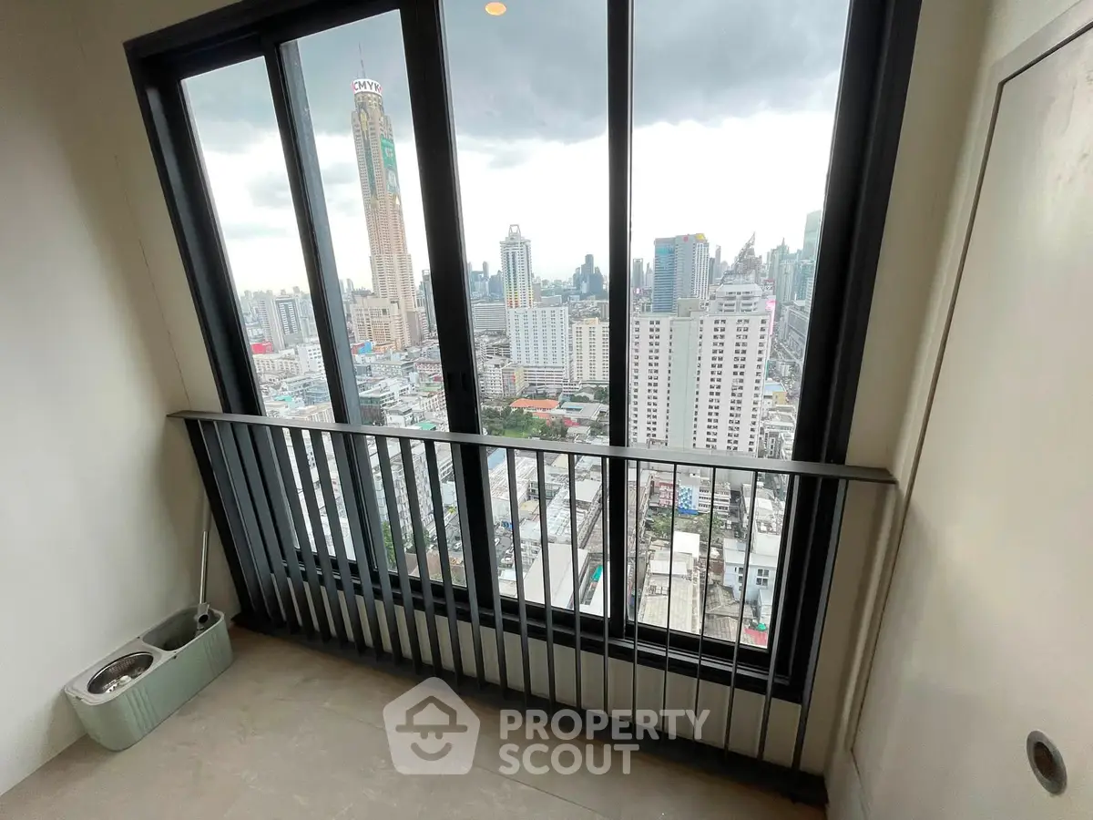 Stunning cityscape view from high-rise apartment balcony with sleek railing design.