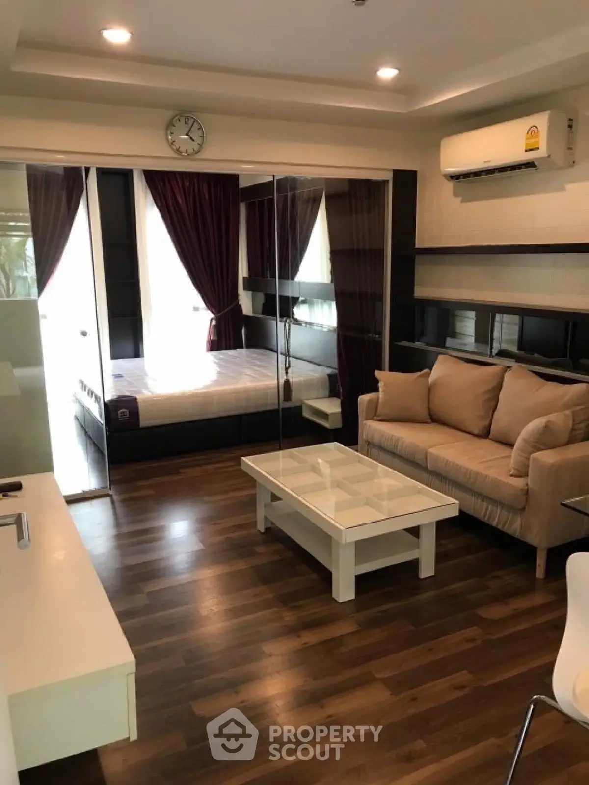 Modern studio apartment with cozy living area and stylish bedroom