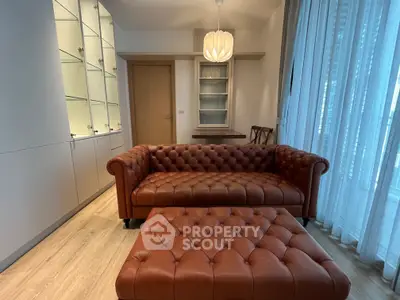 Luxurious living room with elegant leather sofa and modern lighting in a stylish apartment.