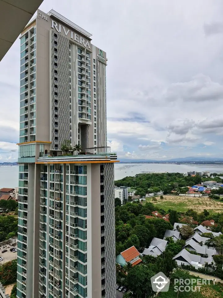 Stunning high-rise building with panoramic sea views and lush surroundings.