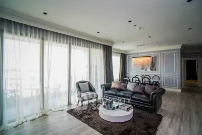 Luxurious living room with elegant decor and large windows offering natural light.