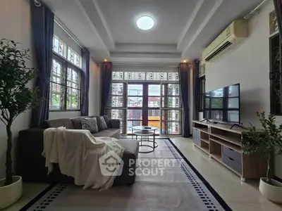 Spacious living room with modern decor and large windows for natural light