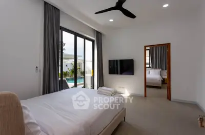 Spacious modern bedroom with pool view and sleek interior design.