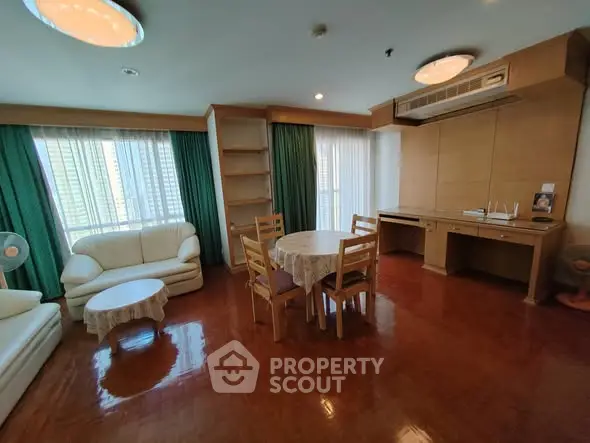 Spacious living room with elegant wooden flooring and natural light