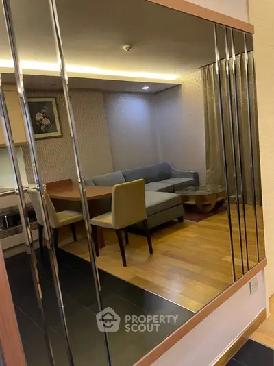 Modern living room with stylish decor and comfortable seating in a cozy apartment setting.