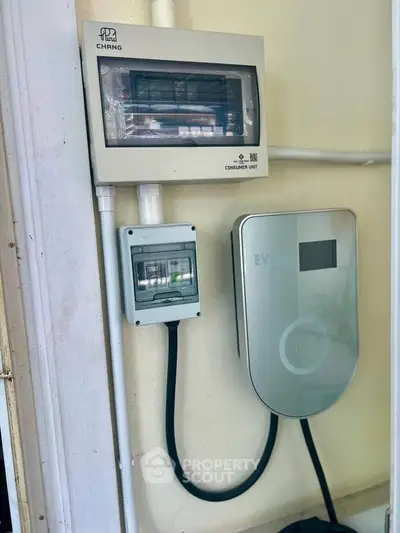 Modern electrical panel and EV charger setup in residential property.