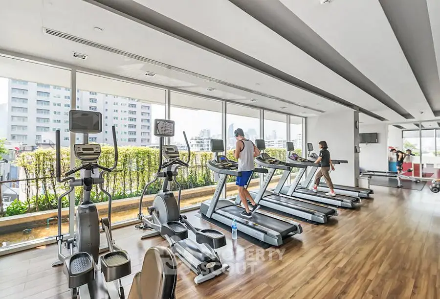 Spacious modern gym with city view and state-of-the-art equipment