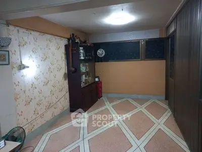 Spacious living room with vintage decor and patterned flooring