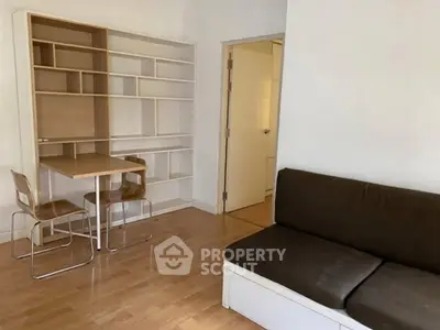 Cozy living room with modern furniture and built-in shelving, perfect for urban living.