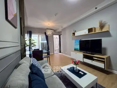 Modern living room with stylish decor and open layout, featuring a cozy sofa and wall-mounted TV.