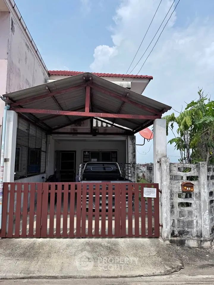 Charming residential property with covered parking and gated entrance.