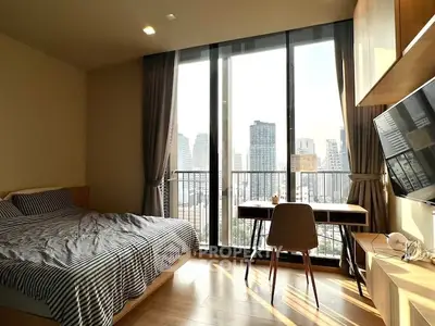 Modern bedroom with city view, large windows, and stylish decor in urban apartment.