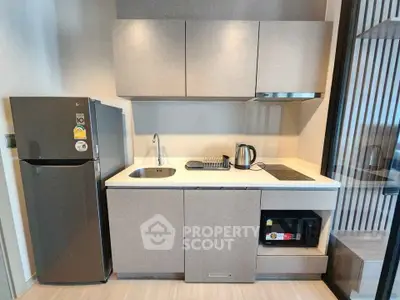 Modern compact kitchen with sleek cabinetry, built-in appliances, and minimalist design.