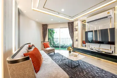Luxurious living room with modern decor, large TV, and balcony view