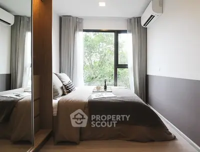 Modern bedroom with large window and stylish decor in a cozy apartment