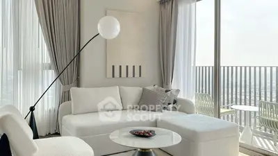 Modern living room with elegant decor and large windows offering stunning city views.