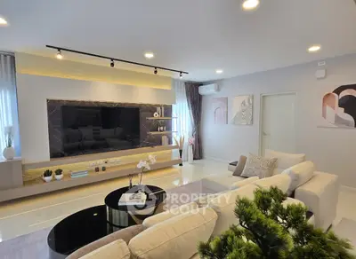 Luxurious modern living room with elegant decor and large flat-screen TV
